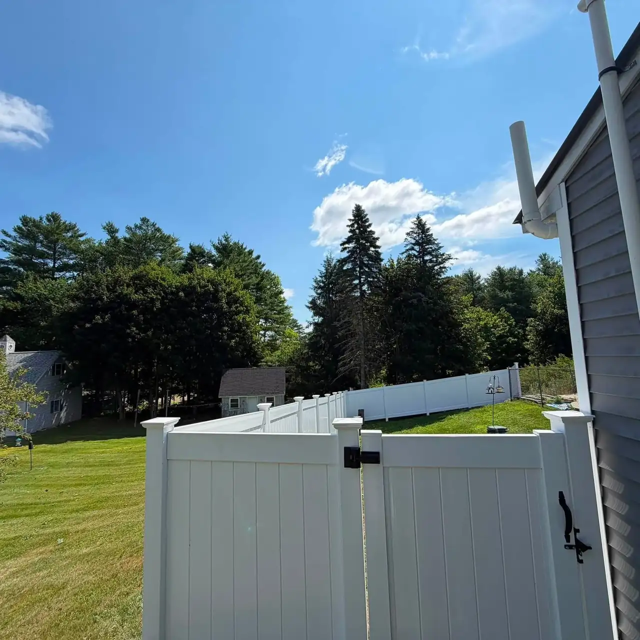 White vinyl gate beside a home