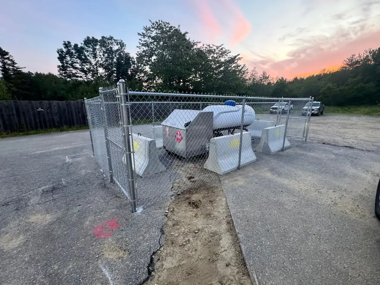 Chain link utility enclosure at sunset
